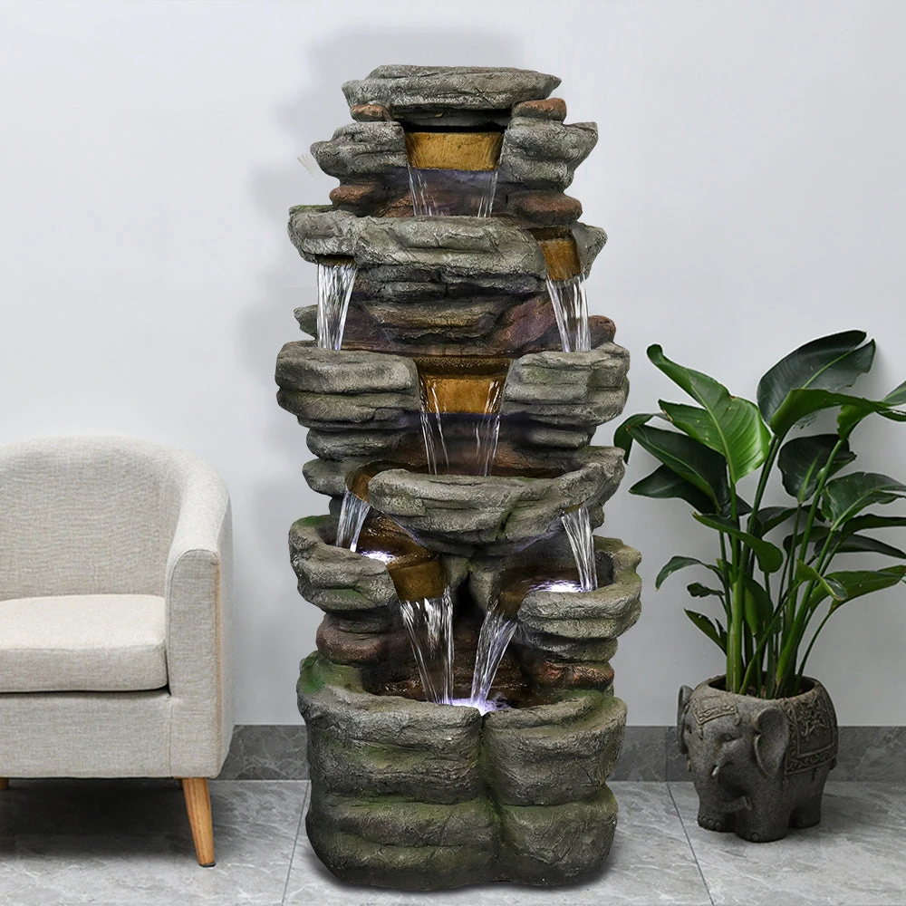indoor rock water fountain - close up of water flowing over indoor rock fountain